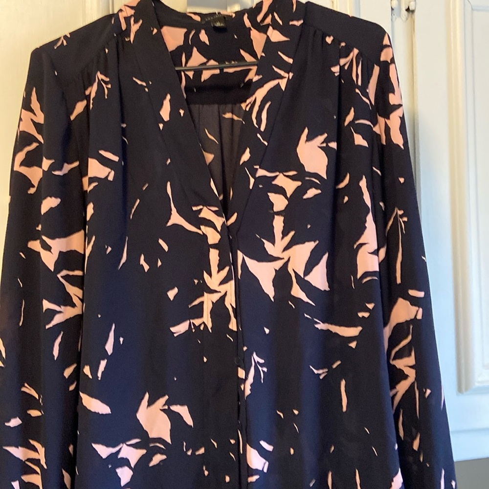 Woman’s blue and pink blouse.